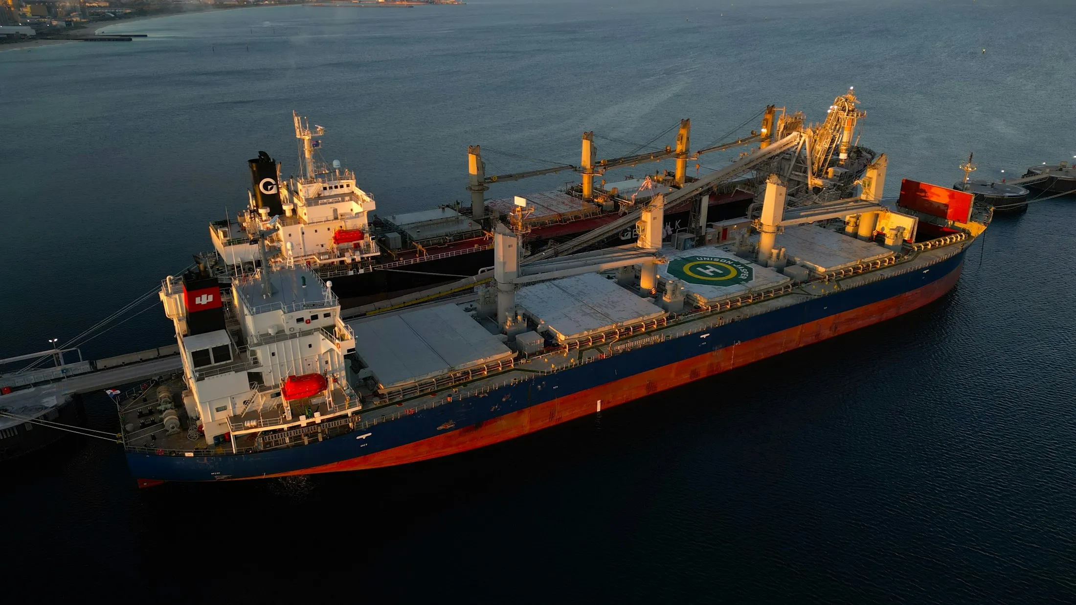 Two bulk carriers at anchor, aerial view